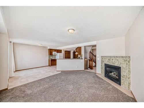 184 Bridlewood Road Sw, Calgary, AB - Indoor Photo Showing Living Room With Fireplace