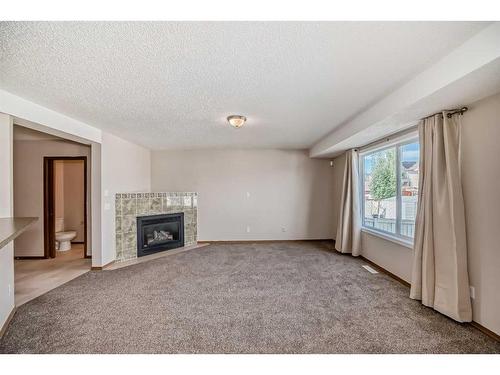 184 Bridlewood Road Sw, Calgary, AB - Indoor Photo Showing Other Room With Fireplace