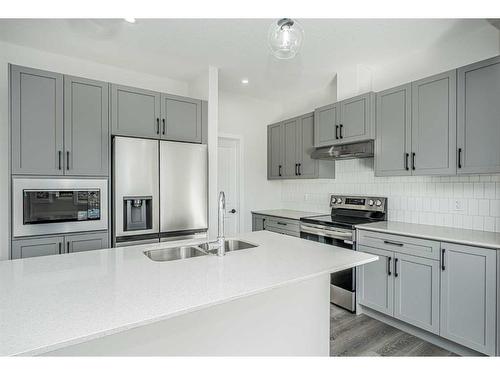 958 Bayview Rise Sw, Airdrie, AB - Indoor Photo Showing Kitchen With Double Sink With Upgraded Kitchen