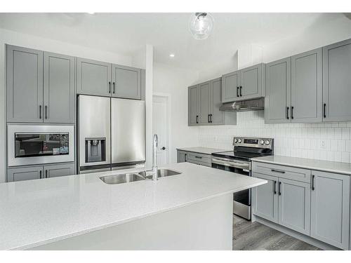 958 Bayview Rise Sw, Airdrie, AB - Indoor Photo Showing Kitchen With Double Sink With Upgraded Kitchen