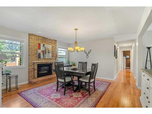 12207 Lake Fraser Way Se, Calgary, AB - Indoor Photo Showing Dining Room With Fireplace