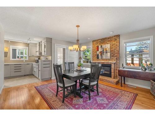 12207 Lake Fraser Way Se, Calgary, AB - Indoor Photo Showing Dining Room With Fireplace