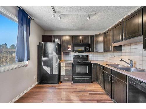 21 Cedarwood Hill Sw, Calgary, AB - Indoor Photo Showing Kitchen With Double Sink