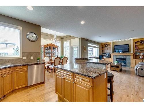 105 Everglade Circle Sw, Calgary, AB - Indoor Photo Showing Kitchen With Fireplace