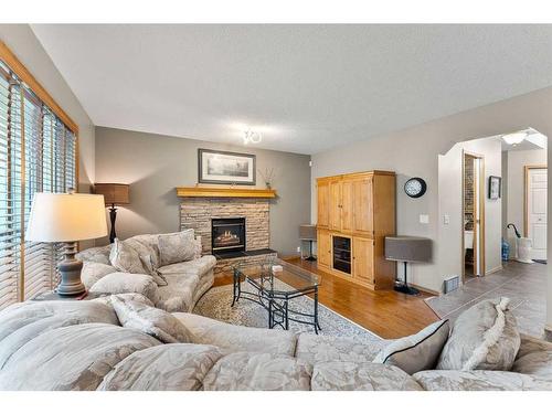 268 Rocky Ridge Bay Nw, Calgary, AB - Indoor Photo Showing Living Room With Fireplace