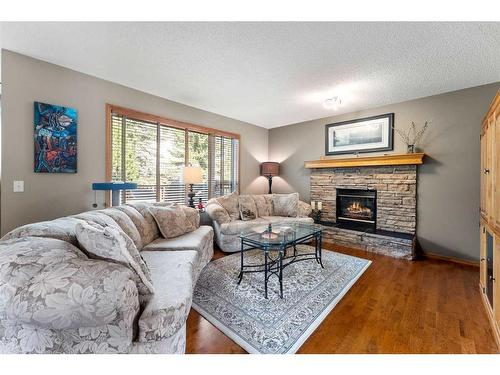 268 Rocky Ridge Bay Nw, Calgary, AB - Indoor Photo Showing Living Room With Fireplace