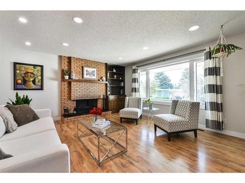 5128 Viceroy Drive Nw, Calgary, AB - Indoor Photo Showing Living Room With Fireplace