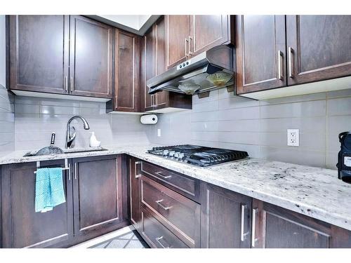 7 Kingsbury Close Se, Airdrie, AB - Indoor Photo Showing Kitchen With Upgraded Kitchen