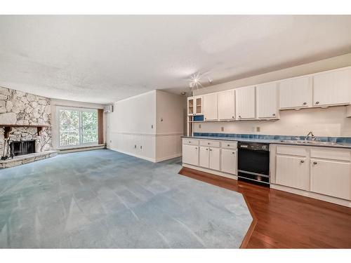 309-1001 68 Avenue Sw, Calgary, AB - Indoor Photo Showing Kitchen With Fireplace With Double Sink