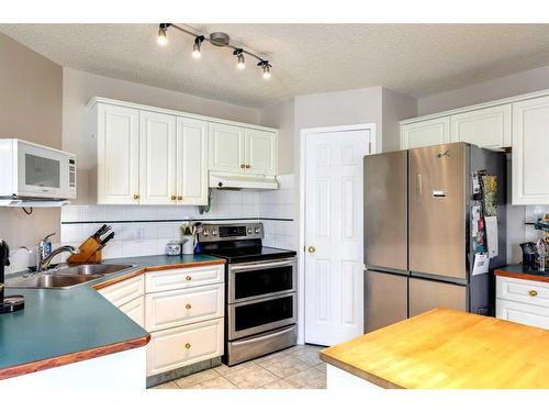 235 Arbour Wood Close Nw, Calgary, AB - Indoor Photo Showing Kitchen With Double Sink