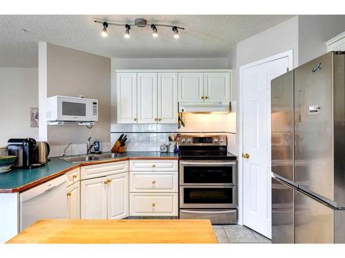 235 Arbour Wood Close Nw, Calgary, AB - Indoor Photo Showing Kitchen With Double Sink