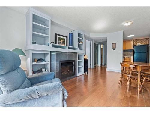 103-333 5 Avenue Ne, Calgary, AB - Indoor Photo Showing Living Room With Fireplace