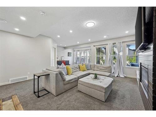 272 Kingsmere Cove Se, Airdrie, AB - Indoor Photo Showing Living Room With Fireplace