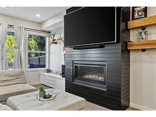 272 Kingsmere Cove Se, Airdrie, AB - Indoor Photo Showing Living Room With Fireplace