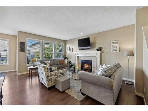 272 Kingsmere Cove Se, Airdrie, AB - Indoor Photo Showing Living Room With Fireplace