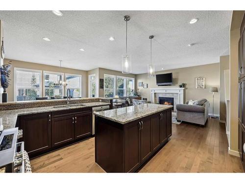 272 Kingsmere Cove Se, Airdrie, AB - Indoor Photo Showing Kitchen With Fireplace With Double Sink