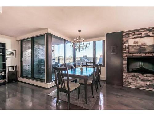 801A-500 Eau Claire Avenue Sw, Calgary, AB - Indoor Photo Showing Dining Room With Fireplace