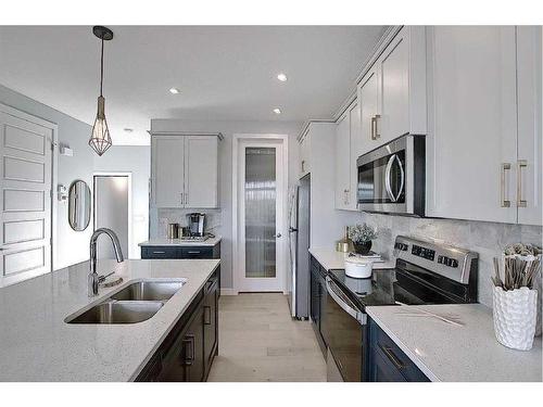 91 Waterford Manor, Chestermere, AB - Indoor Photo Showing Kitchen With Double Sink With Upgraded Kitchen