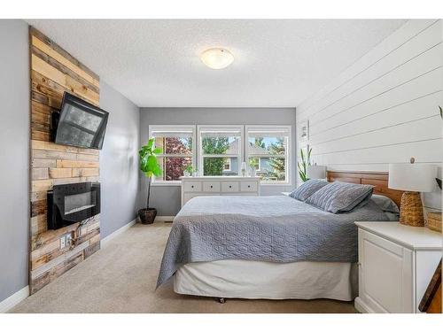 15 Mahogany Point Se, Calgary, AB - Indoor Photo Showing Bedroom With Fireplace