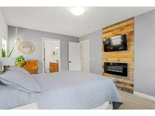 15 Mahogany Point Se, Calgary, AB - Indoor Photo Showing Bedroom With Fireplace