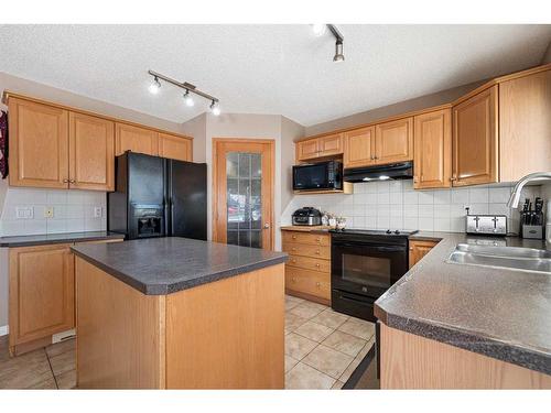 78 Cranston Drive Se, Calgary, AB - Indoor Photo Showing Kitchen With Double Sink