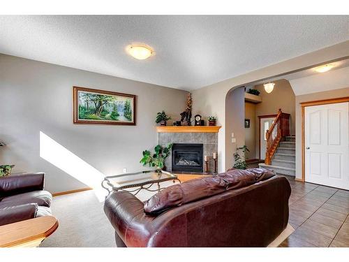 408 Bridlemeadows Common Sw, Calgary, AB - Indoor Photo Showing Living Room With Fireplace