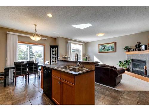 408 Bridlemeadows Common Sw, Calgary, AB - Indoor Photo Showing Kitchen With Fireplace With Double Sink