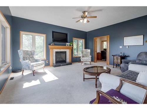 602 Pheasant Close, Pelican Point, AB - Indoor Photo Showing Living Room With Fireplace