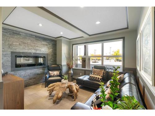 2111-10 Market Boulevard Se, Airdrie, AB - Indoor Photo Showing Living Room With Fireplace