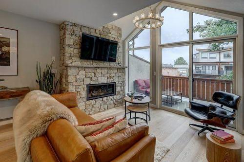 1-825 7Th Street North, Canmore, AB - Indoor Photo Showing Living Room With Fireplace