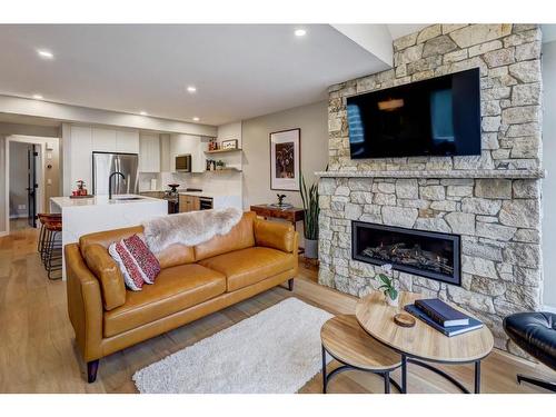 1-825 7Th Street North, Canmore, AB - Indoor Photo Showing Living Room With Fireplace