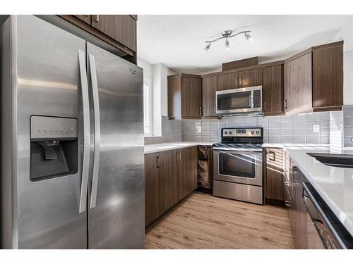 316 Windford Green Sw, Airdrie, AB - Indoor Photo Showing Kitchen With Double Sink With Upgraded Kitchen