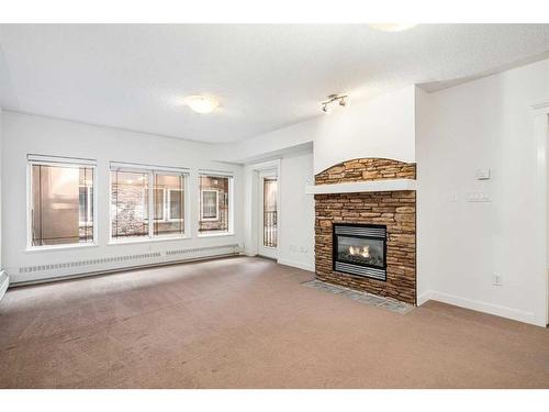 118-30 Discovery Ridge Close Sw, Calgary, AB - Indoor Photo Showing Living Room With Fireplace