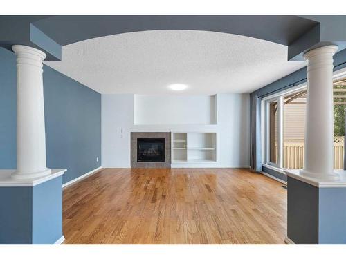 23 River Rock Place Se, Calgary, AB - Indoor Photo Showing Living Room With Fireplace