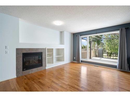 23 River Rock Place Se, Calgary, AB - Indoor Photo Showing Living Room With Fireplace