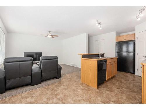 102-800 Yankee Valley Boulevard Se, Airdrie, AB - Indoor Photo Showing Kitchen With Double Sink