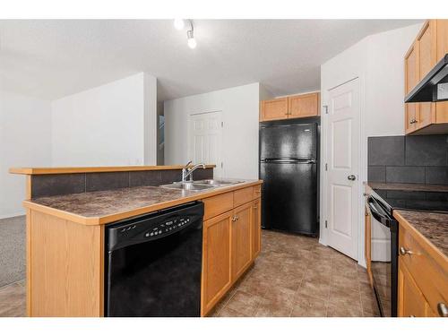 102-800 Yankee Valley Boulevard Se, Airdrie, AB - Indoor Photo Showing Kitchen With Double Sink