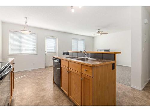 102-800 Yankee Valley Boulevard Se, Airdrie, AB - Indoor Photo Showing Kitchen With Double Sink