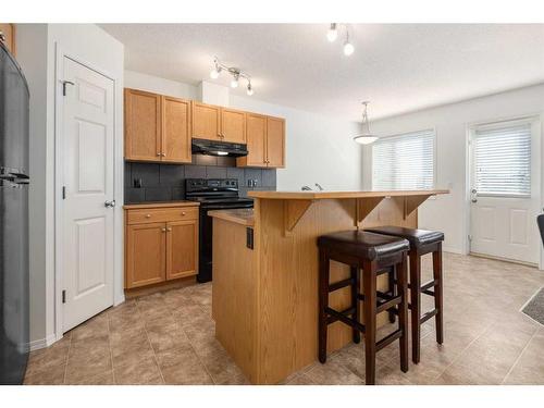 102-800 Yankee Valley Boulevard Se, Airdrie, AB - Indoor Photo Showing Kitchen