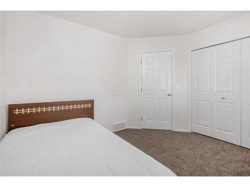 102-800 Yankee Valley Boulevard Se, Airdrie, AB - Indoor Photo Showing Bedroom