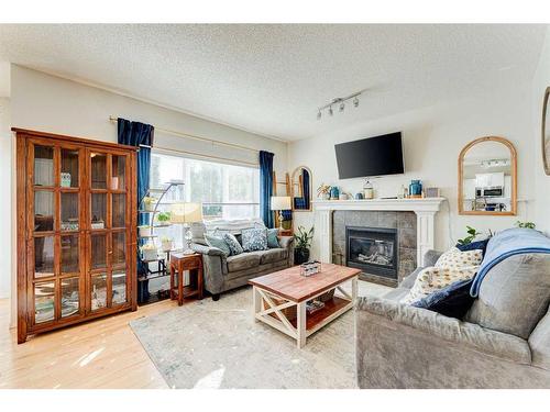 71 Copperfield Point Se, Calgary, AB - Indoor Photo Showing Living Room With Fireplace