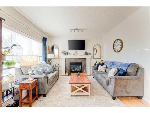 71 Copperfield Point Se, Calgary, AB - Indoor Photo Showing Living Room With Fireplace