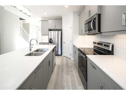 23 Wolf Hollow Way Se, Calgary, AB - Indoor Photo Showing Kitchen With Stainless Steel Kitchen With Double Sink With Upgraded Kitchen