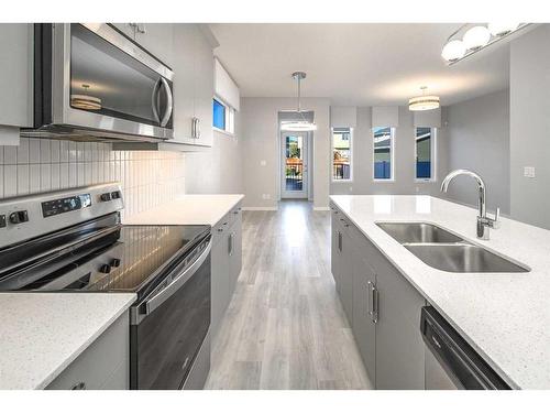 23 Wolf Hollow Way Se, Calgary, AB - Indoor Photo Showing Kitchen With Stainless Steel Kitchen With Double Sink With Upgraded Kitchen