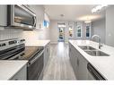 23 Wolf Hollow Way Se, Calgary, AB  - Indoor Photo Showing Kitchen With Stainless Steel Kitchen With Double Sink With Upgraded Kitchen 