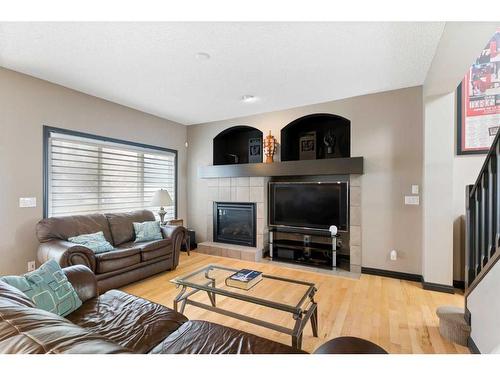 168 Sunset View, Cochrane, AB - Indoor Photo Showing Living Room With Fireplace