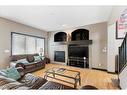 168 Sunset View, Cochrane, AB  - Indoor Photo Showing Living Room With Fireplace 