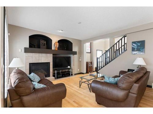 168 Sunset View, Cochrane, AB - Indoor Photo Showing Living Room With Fireplace