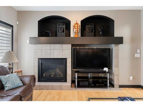 168 Sunset View, Cochrane, AB - Indoor Photo Showing Living Room With Fireplace