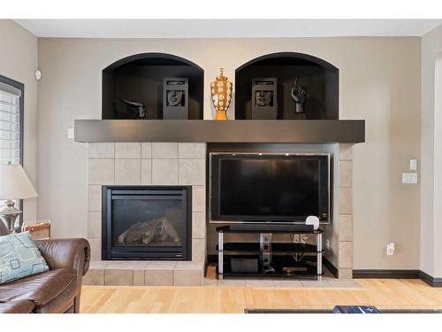 168 Sunset View, Cochrane, AB - Indoor Photo Showing Living Room With Fireplace